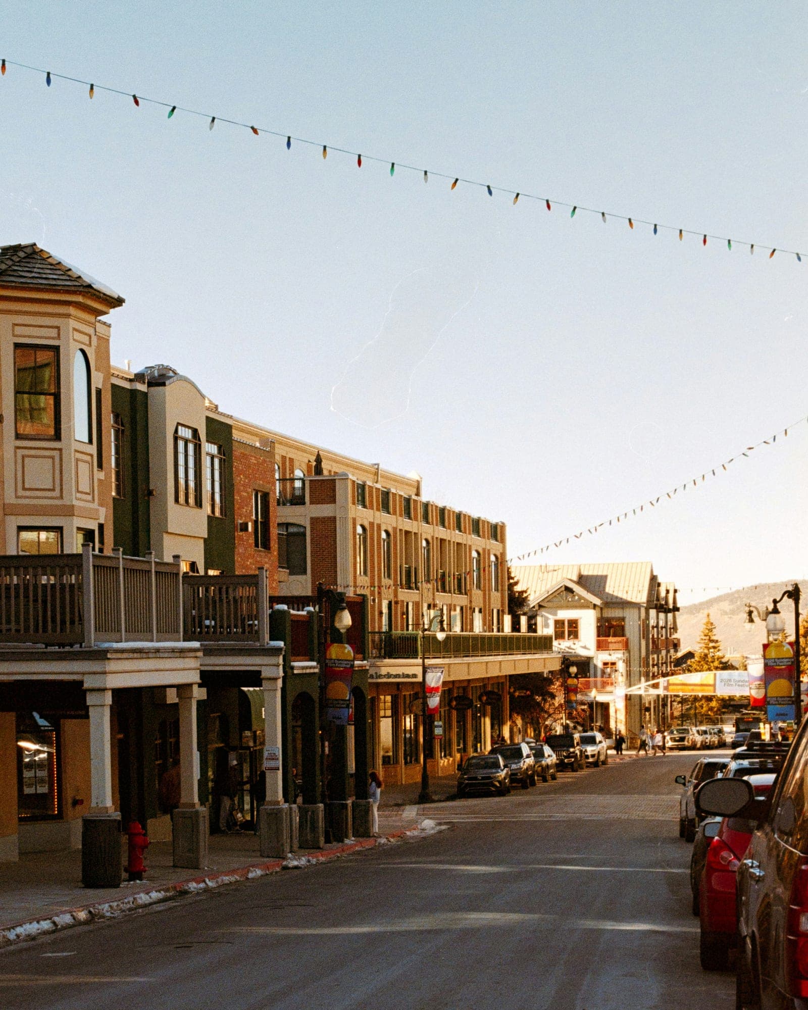 Storefronts under strings of lights at dusk on Park City's Main Street, Utah